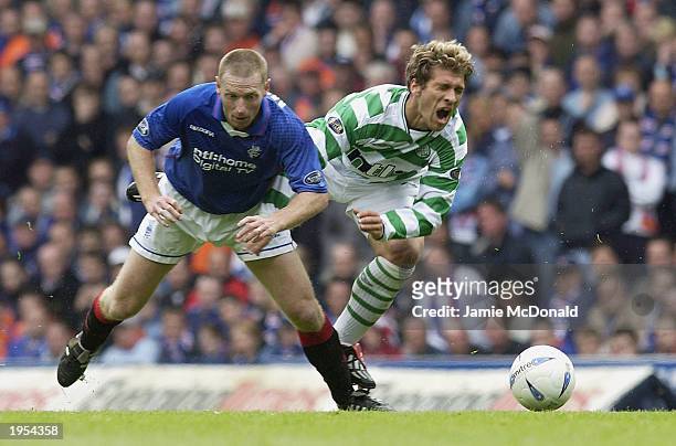 Graig Moore of Glasgow tackles Steillian Pedrov of Celtic during the Bank of Scotland Scottish Premier League match between Glasgow Rangers and...