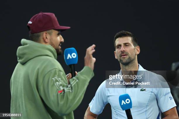 Novak Djokovic of Serbia is interviewed by Nick Kyrgios after their quarterfinals singles match against Taylor Fritz of the United States during the...