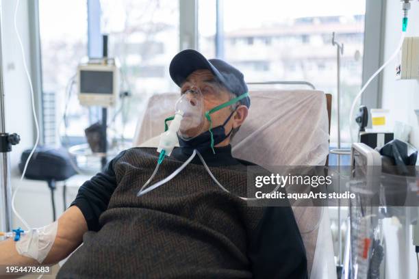 senior man connected to ventilator in hospital - hospital ventilator stock pictures, royalty-free photos & images