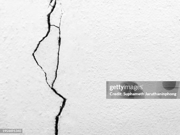 fragmented foundations: a cracked concrete texture for a broken wall concept. - rotto foto e immagini stock