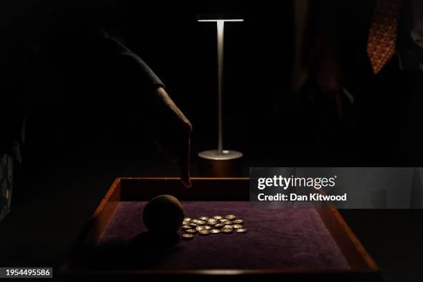 Hoard of 26 Iron Age gold coins that were discovered hidden inside a flint container in West Berkshire, are displayed at the British Museum's...