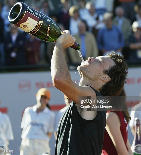 Carlos Moya of Spain drinks Cava champagne after winning the Seat Open Men's Final against Marat Safin of Russia at the Real Club de Tenis on April...