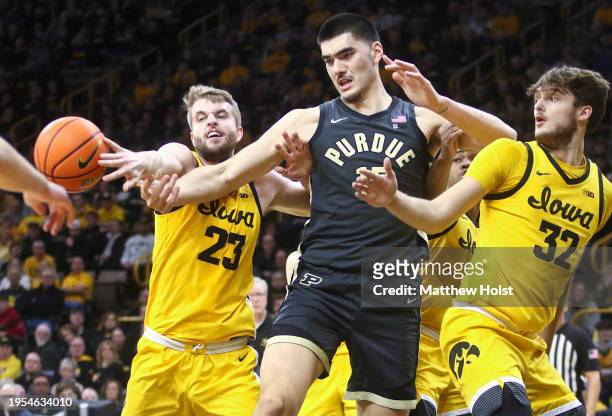 Center Zach Edey of the Purdue Boilermakers battles for a rebound during the first half against forward Owen Freeman and forward Ben Krikke of the...
