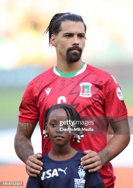 Iban Salvador of Equatorial Guinea lines up with a mascot before the TotalEnergies CAF Africa Cup of Nations group stage match between Equatorial...