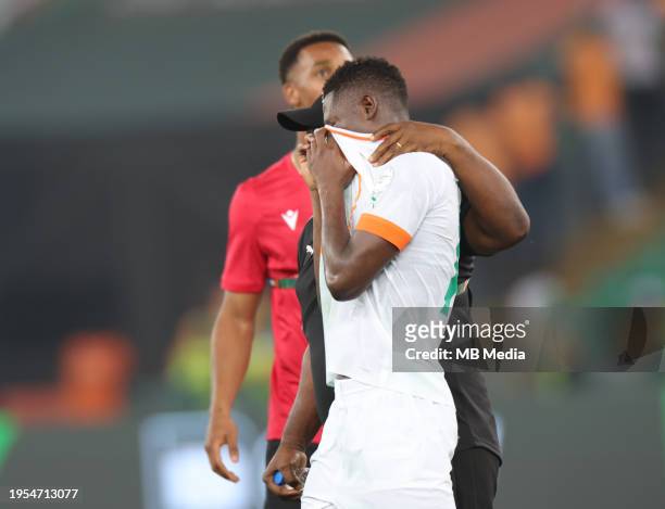 Karim Konaté of Ivory Coast is comforted after the TotalEnergies CAF Africa Cup of Nations group stage match between Equatorial Guinea and Ivory...