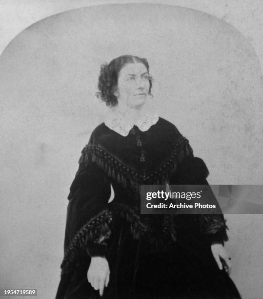 Irish actress and dancer Lola Montez wearing a dark dress with a white collar in a studio portrait, United States, circa 1860. The image is one-half...