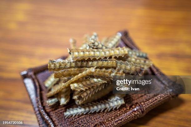 traditional japanese cuisine, grilled dried eel bones - fish on line stock pictures, royalty-free photos & images