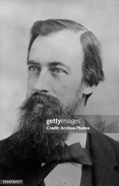 Headshot of Professor Henry D Noyes, wearing a dark jacket over a white shirt with a bow tie, in a studio portrait in New York City, New York, circa...