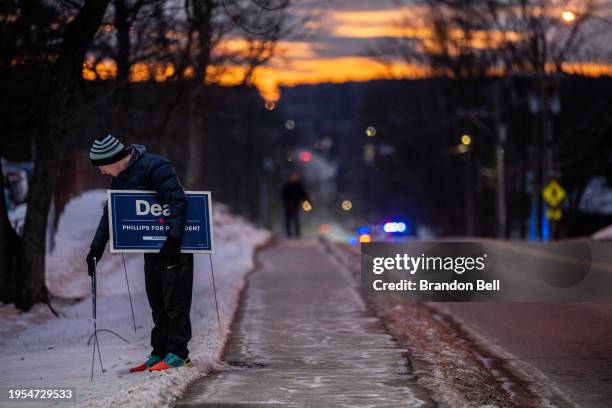 Person puts out 'Dean Phillips' signage at Pinkerton Academy on January 23, 2024 in Derry, New Hampshire. People around the state are heading to the...