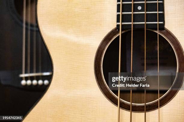 detail of a wooden string instrument that resembles an acoustic guitar - musical instrument string stock pictures, royalty-free photos & images