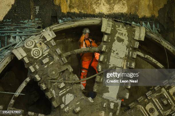 Construction worker waves from Lydia, an 847 tonne tunnel boring machine after breaking through into the underground box at HS2's Old Oak Common...