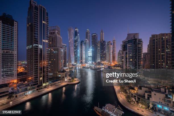 aerial view of cityscape and skyscraper at night in dubai marina. - persian gulf stock pictures, royalty-free photos & images