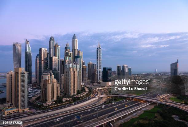 aerial view of city skyline and cityscape in dubai uae. - dubai stock pictures, royalty-free photos & images