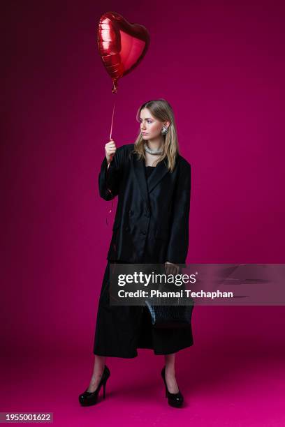 fashionable woman holding a balloon - heart necklace stock pictures, royalty-free photos & images