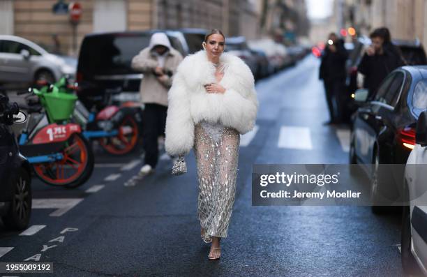 Leonie Hanne seen wearing white short faux fur jacket, laced see trough sequined skirt, mini white shimmery handbag outside Georges Hobeika Show...