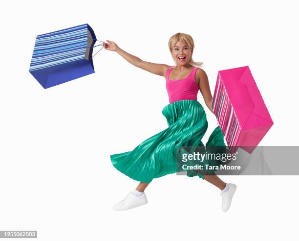 woman running with shopping bags - jump shot stock pictures, royalty-free photos & images