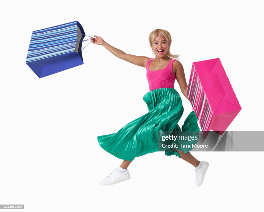 Woman running with shopping bags