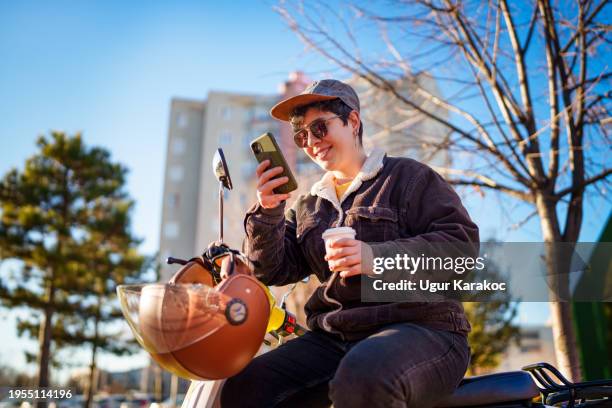 part of a series of a woman using mobile phone on motorbike. - part time job stock pictures, royalty-free photos & images