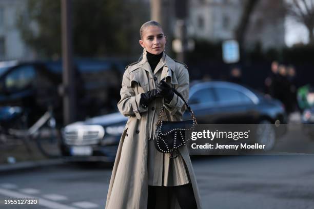 Caroline Daur seen wearing a beige Dior quilted blazer, beige. Pleated beige mini skirt, beige trench coat, black legging tights, black loafer, black...