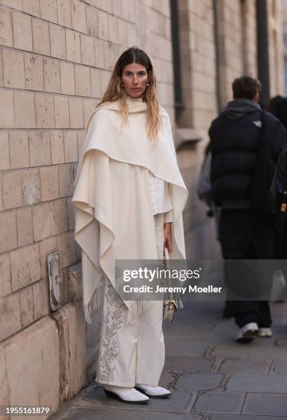 Veronika Heilbrunner seen wearing a cream shirt, cream decorated pants, cream big scarf, white cowboy boots, Dior creem saddle bag, outside Christian...