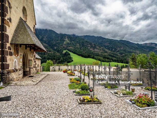 small rural cemetery in front of a small church in the dolomite alps. italy. - pulpit stock pictures, royalty-free photos & images