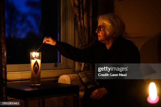 Joan Salter lights a memorial candle at her home in north London, ahead of International Holocaust Remembrance day this weekend, on January 23, 2024...