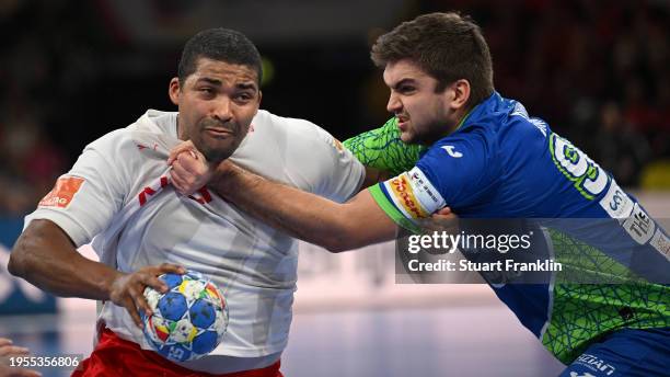 Mads Mensah Larsen of Denmark is challenged by Jernej Drobez of Slovenia during the Men's EHF Euro 2024 main round match between Slovenia and Denmark...