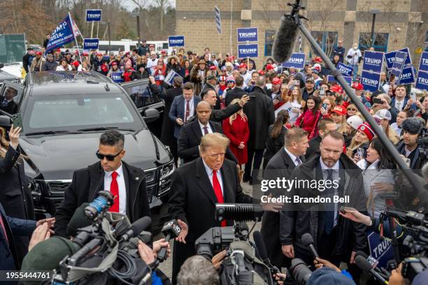 Republican presidential candidate and former President Donald Trump speaks to members of the press outside of Londonderry High School on January 23,...