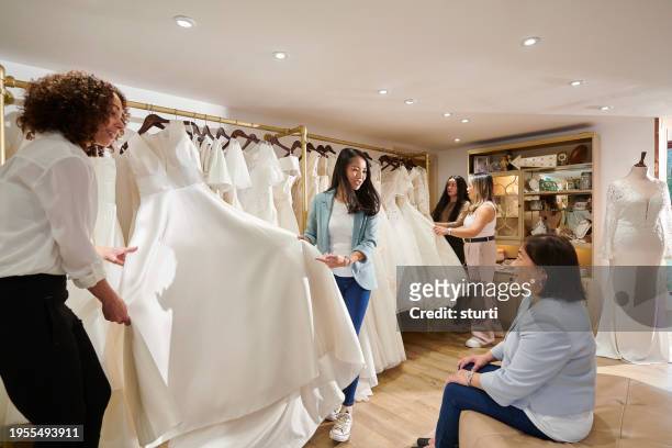 mother and daughter wedding dress shopping - bridal shop stock pictures, royalty-free photos & images