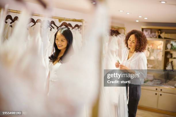 bridal gown shopping - bridal shop stock pictures, royalty-free photos & images