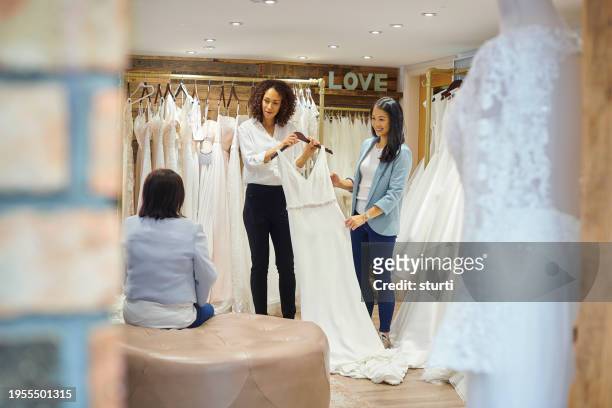 mother and daughter wedding dress shopping - bridal shop stock pictures, royalty-free photos & images