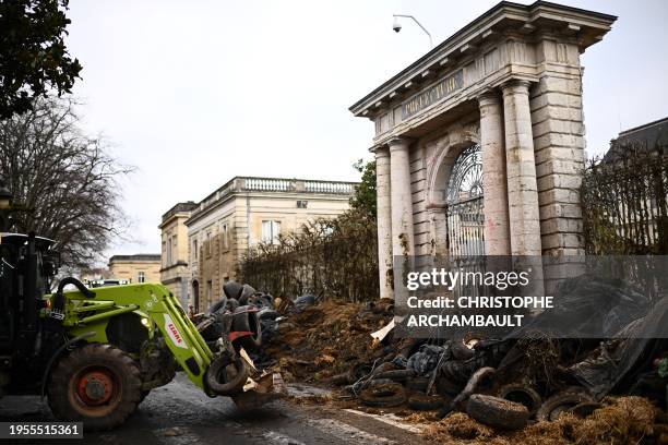 Farmers of the CR47 union dump tyres and debris at the entrance of the prefecture in Agen, southwestern France, on January 26, 2024. As they await...