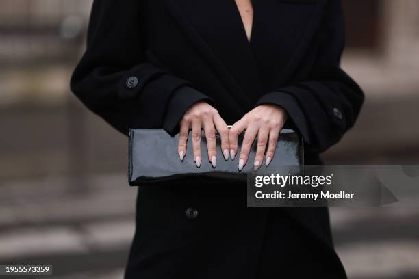 Sasha Ray seen wearing elegant long wool coat, black shiny varnished leather clutch bag, before Georges Chakra, during the Haute Couture...