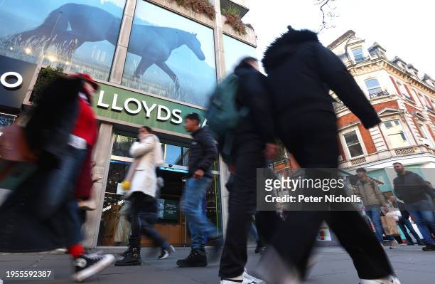 People walk past a branch of Lloyds Bank on Oxford street on January 26, 2024 in London, England. This week, Lloyds Banking Group, which also owns...