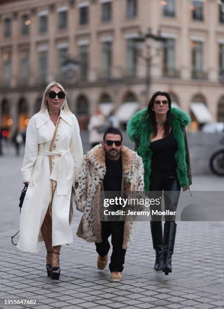 Corina Mihaila Larpin seen wearing Stefere Jewelry black / silver diamond earrings / hoops, cream white long wool coat with gold details, black...