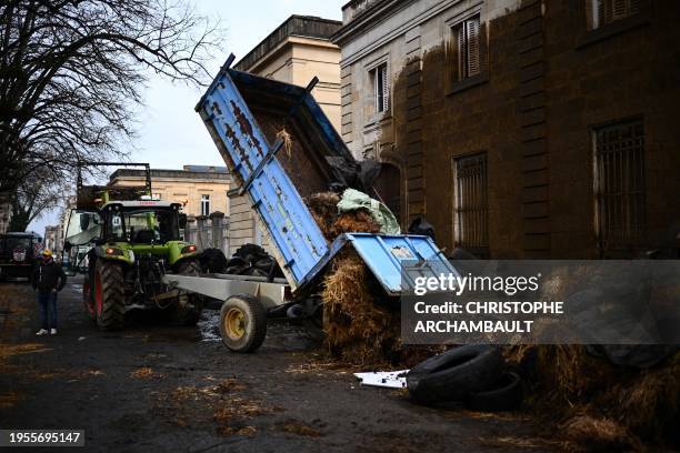 Farmers of the CR47 union dump manure and debris at the entrance of the prefecture in Agen, southwestern France, on January 26, 2024. As they await...