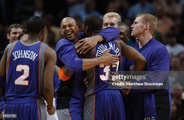 Scott Williams of the Phoenix Suns hugs Amare Stoudemire as fellow teammate Joe Johnson stands nearby in Game one of the Western Conference...