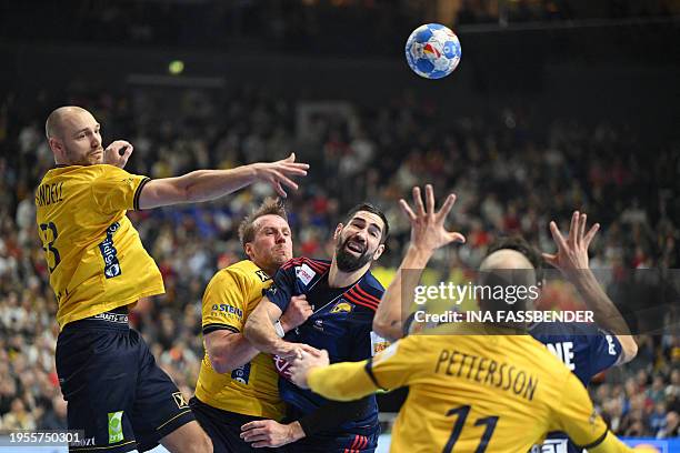 Sweden's right back Lukas Sandell passes the ball next to France's pivot Luka Karabatic during the Men's EURO 2024 EHF Handball European Championship...
