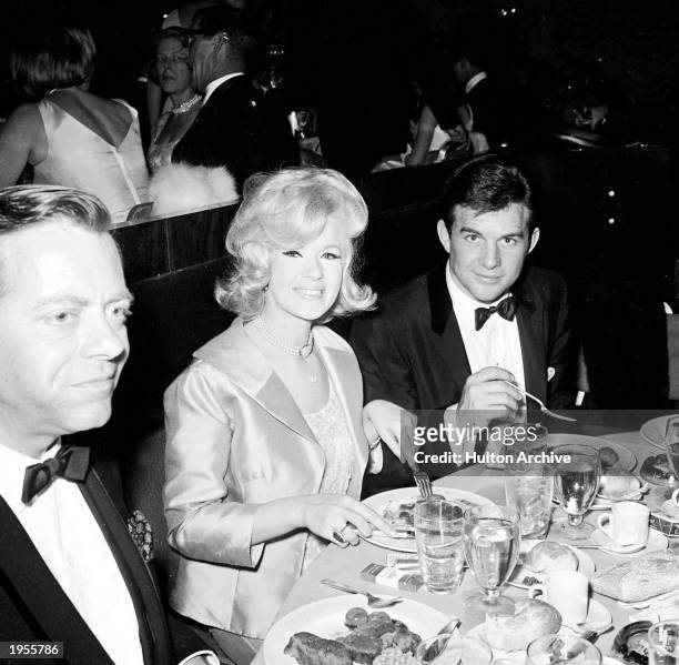 American actor Connie Stevens, her husband James Stacy and American actpr Max Showalter eat during the Academy Awards ceremonies, Santa Monica,...