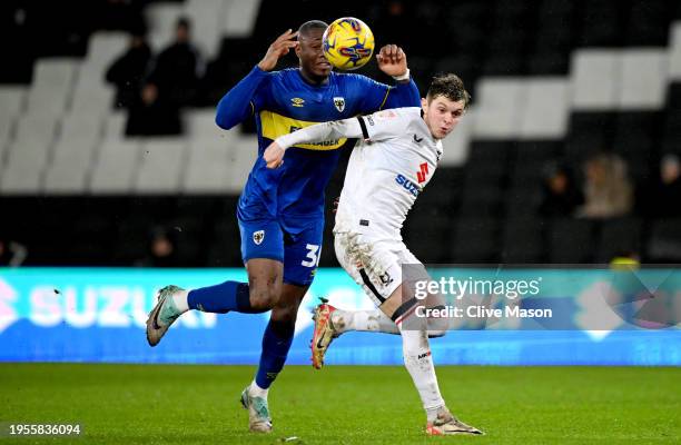 Max Dean of MK Dons is fouled by Paul Kalambayi of AFC Wimbledon which leads to a red card for Paul Kalambayi during the Sky Bet League Two match...