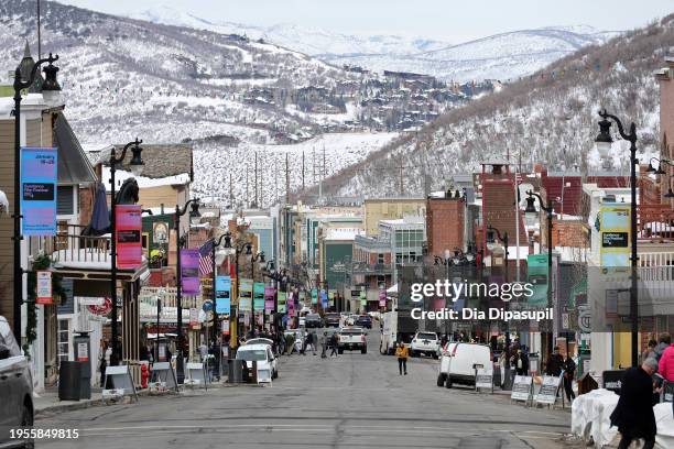 Signage hangs from lamp posts as people walk on Main Street during the 2024 Sundance Film Festival on January 23, 2024 in Park City, Utah.