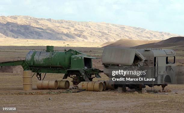 Drums sit next to a pumping system and a mobile laboratory April 28, 2003 after being discovered by U.S. Troops in the outskirts of Baiji in northern...