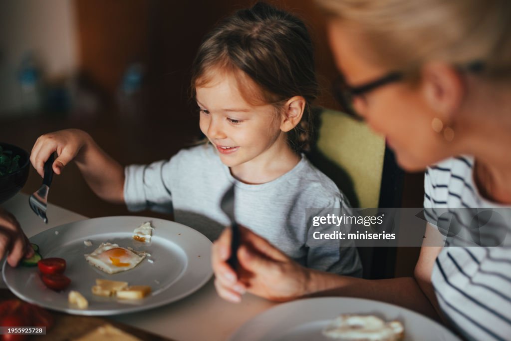A Happy Beautiful Cute Girl Having Breakfast At Home