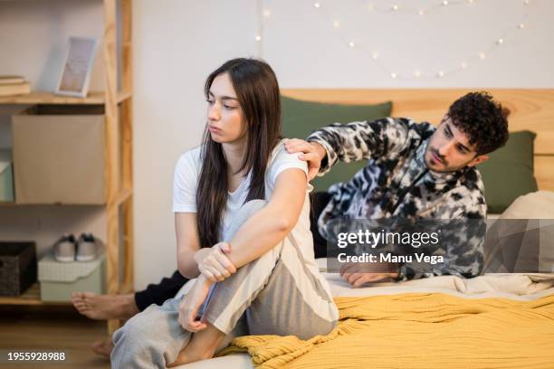 couple going through infidelity troubles sitting in bed. - the end stock pictures, royalty-free photos & images