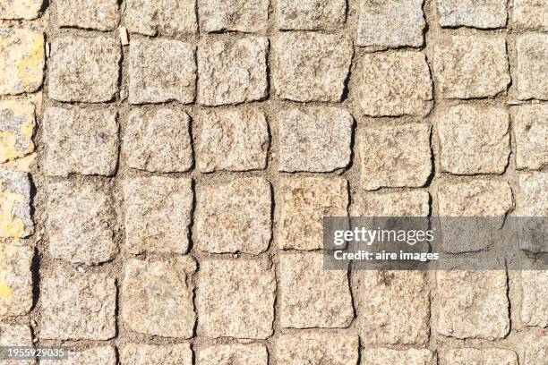 high angle view of brick pavement on a dirt road outdoors with no people around. - adoquinado fotografías e imágenes de stock