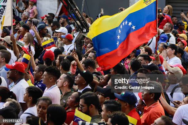 Supporters of President of Venezuela Nicolas Maduro attend a march for the 65th anniversary of the overthrow of dictator Marcos Perez Jimenez on...