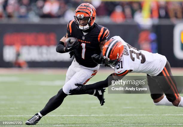 Ja'Marr Chase of the Cincinnati Bengals runs with the ball while defended by Vincent Gray the Cleveland Browns at Paycor Stadium on January 07, 2024...