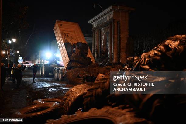 Farmers of the CR47 union dump slurry, manure, tyres and debris at the entrance to the prefecture in Agen, southwestern France, on January 26...