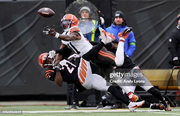 James Proche II the Cleveland Browns while defended by Mike Hilton and Cam Taylor-Britt of the Cincinnati Bengals at Paycor Stadium on January 07,...