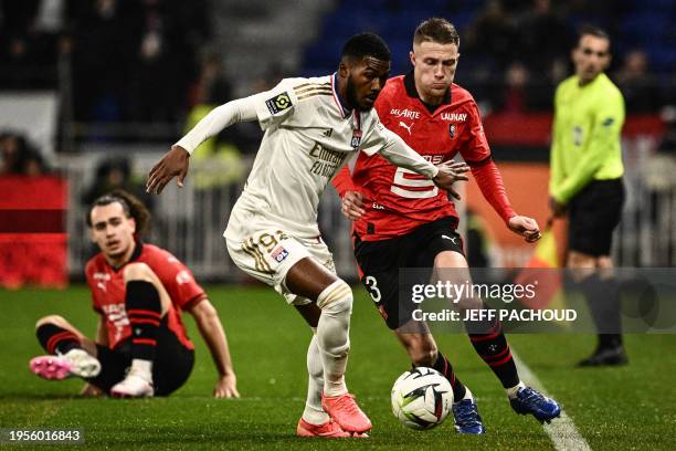 Lyon's English midfielder Ainsley Maitland-Niles fights for the ball with Rennes' French defender Adrien Truffert during the French L1 football match...